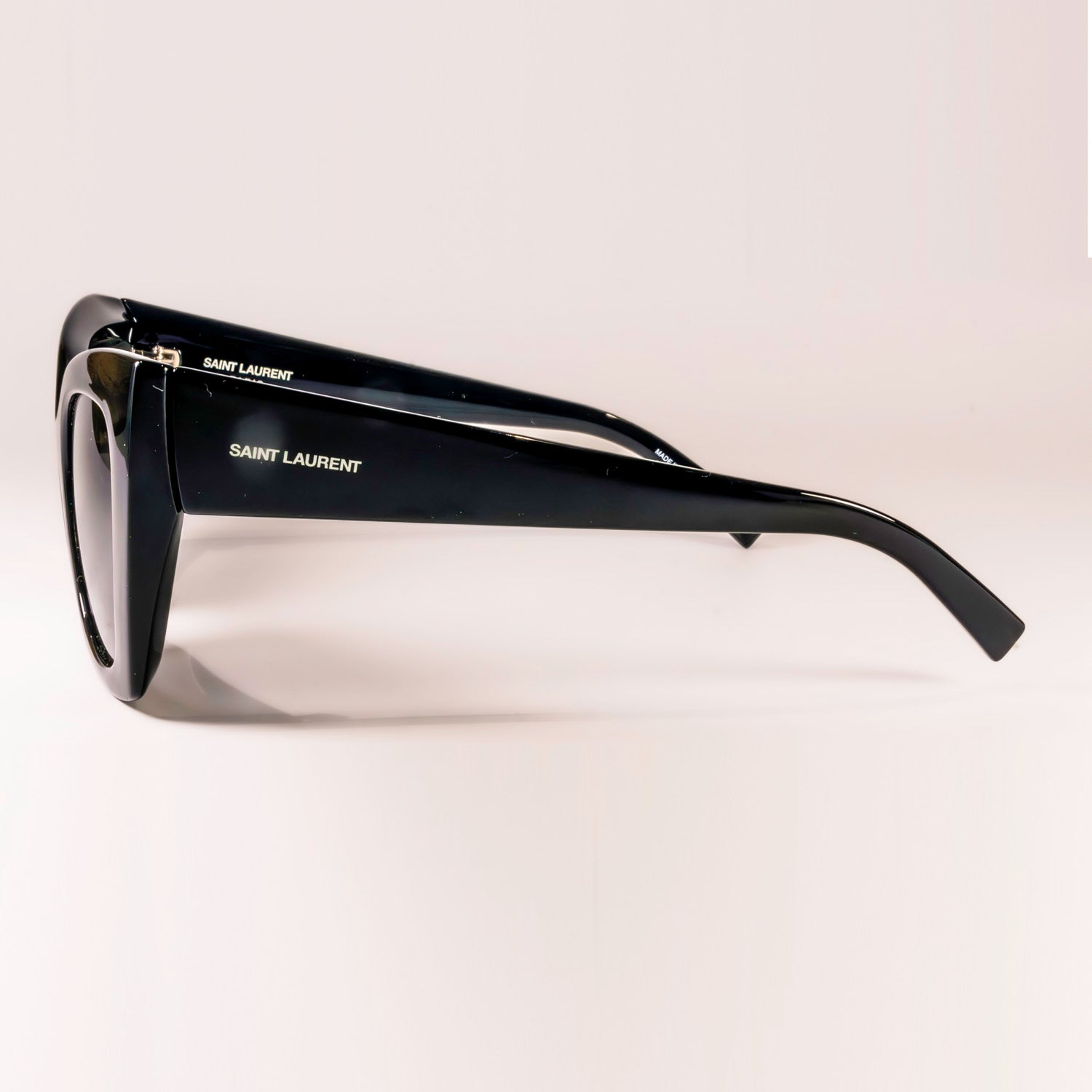 Saint Laurent SL-552 - 001 sunglasses featuring a butterfly shape, metal frame, and nylon lenses, designed for women.