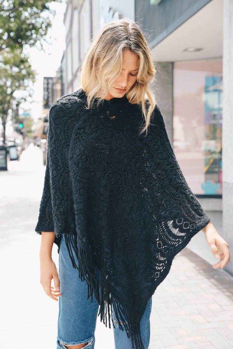 A cozy Scallop Lace Knit Poncho featuring elegant scallop lace details, perfect for chilly days.