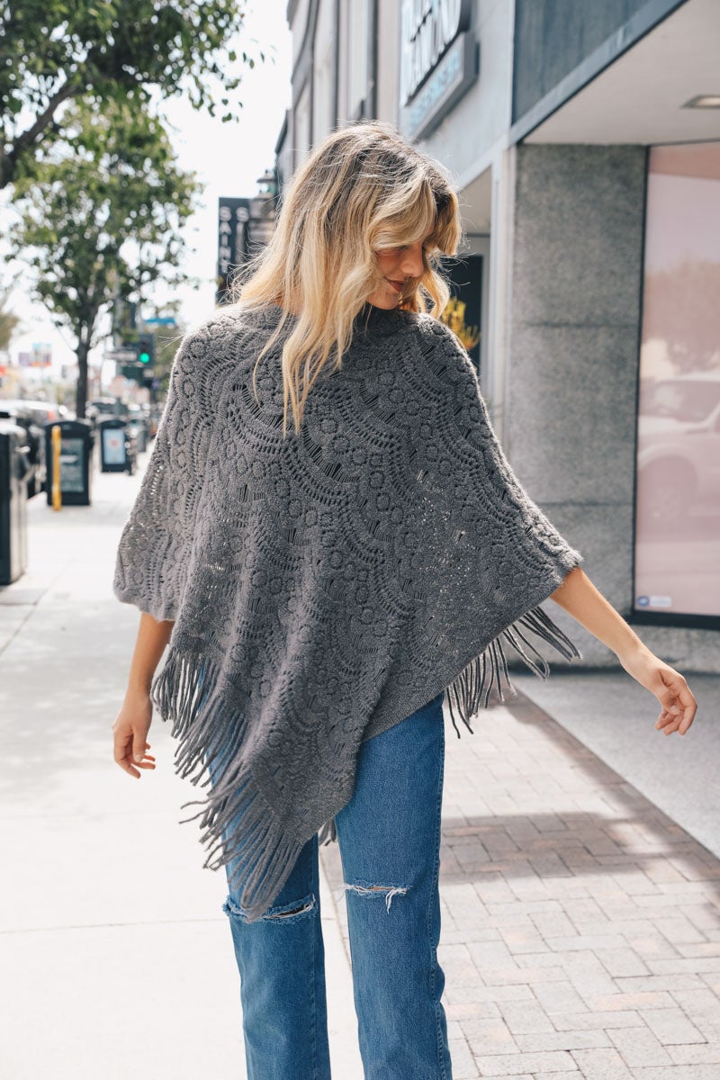 A cozy Scallop Lace Knit Poncho featuring elegant scallop lace details, perfect for chilly days.