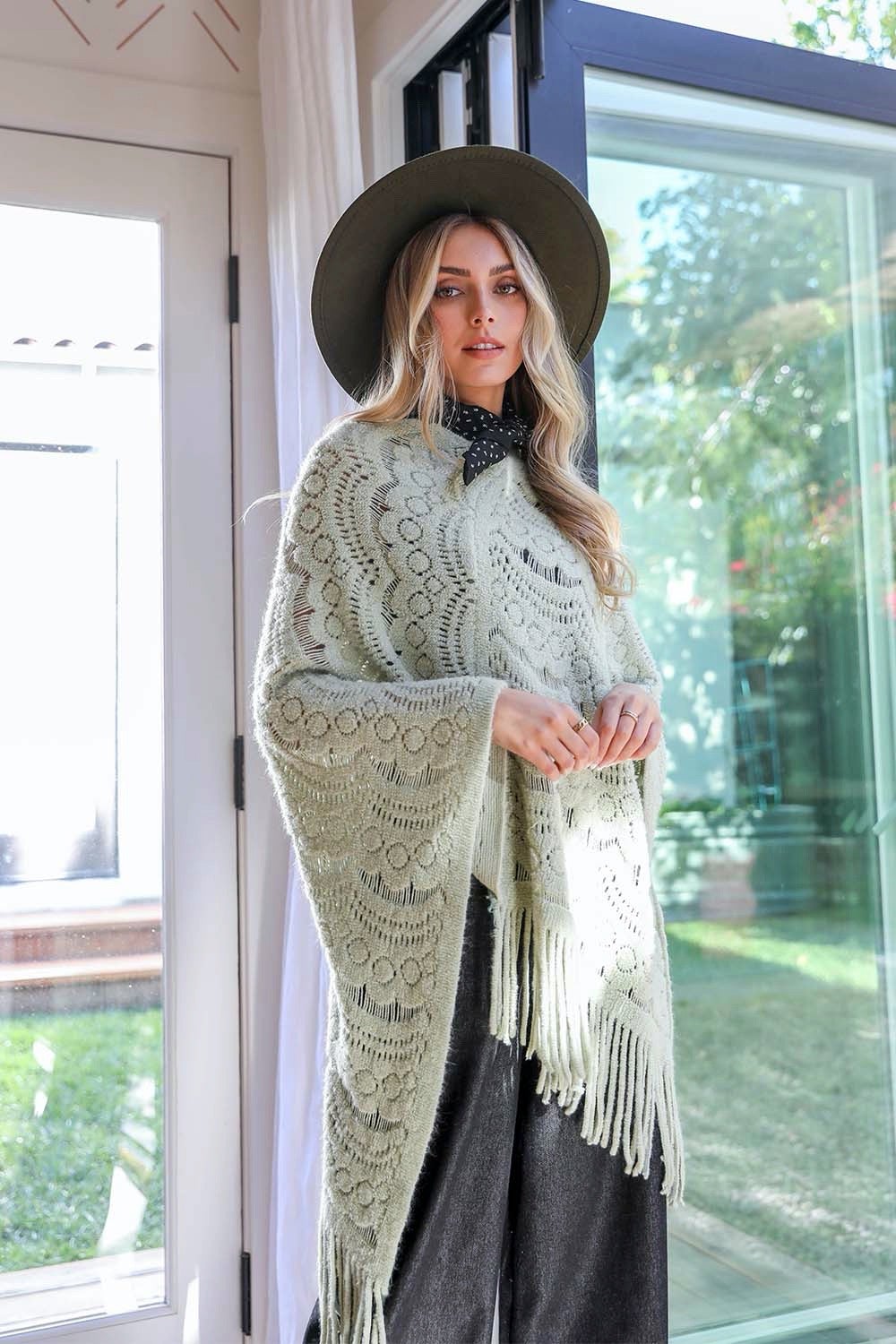 A cozy Scallop Lace Knit Poncho featuring elegant scallop lace details, perfect for chilly days.