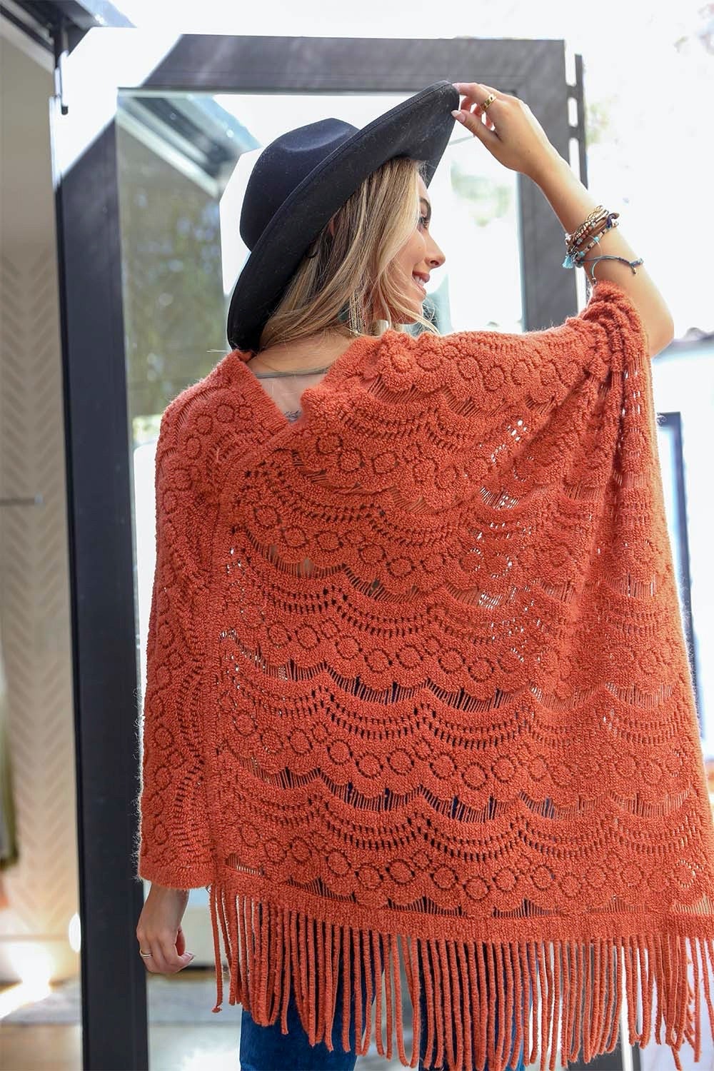 A cozy Scallop Lace Knit Poncho featuring elegant scallop lace details, perfect for chilly days.