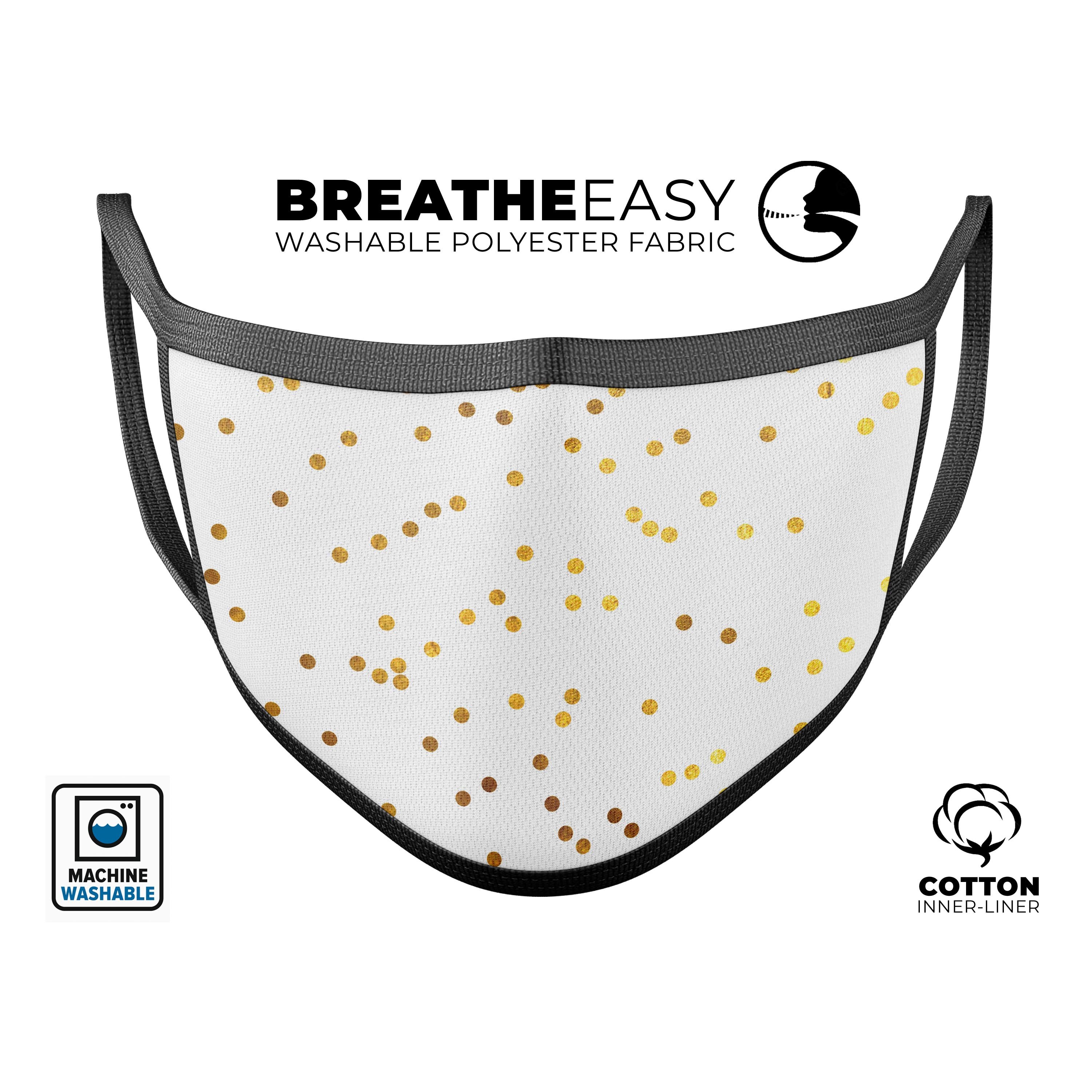 A stylish unisex mouth cover featuring scattered golden micro polka dots, made in the USA, showcasing adjustable ear-loops and a soft cotton interior.