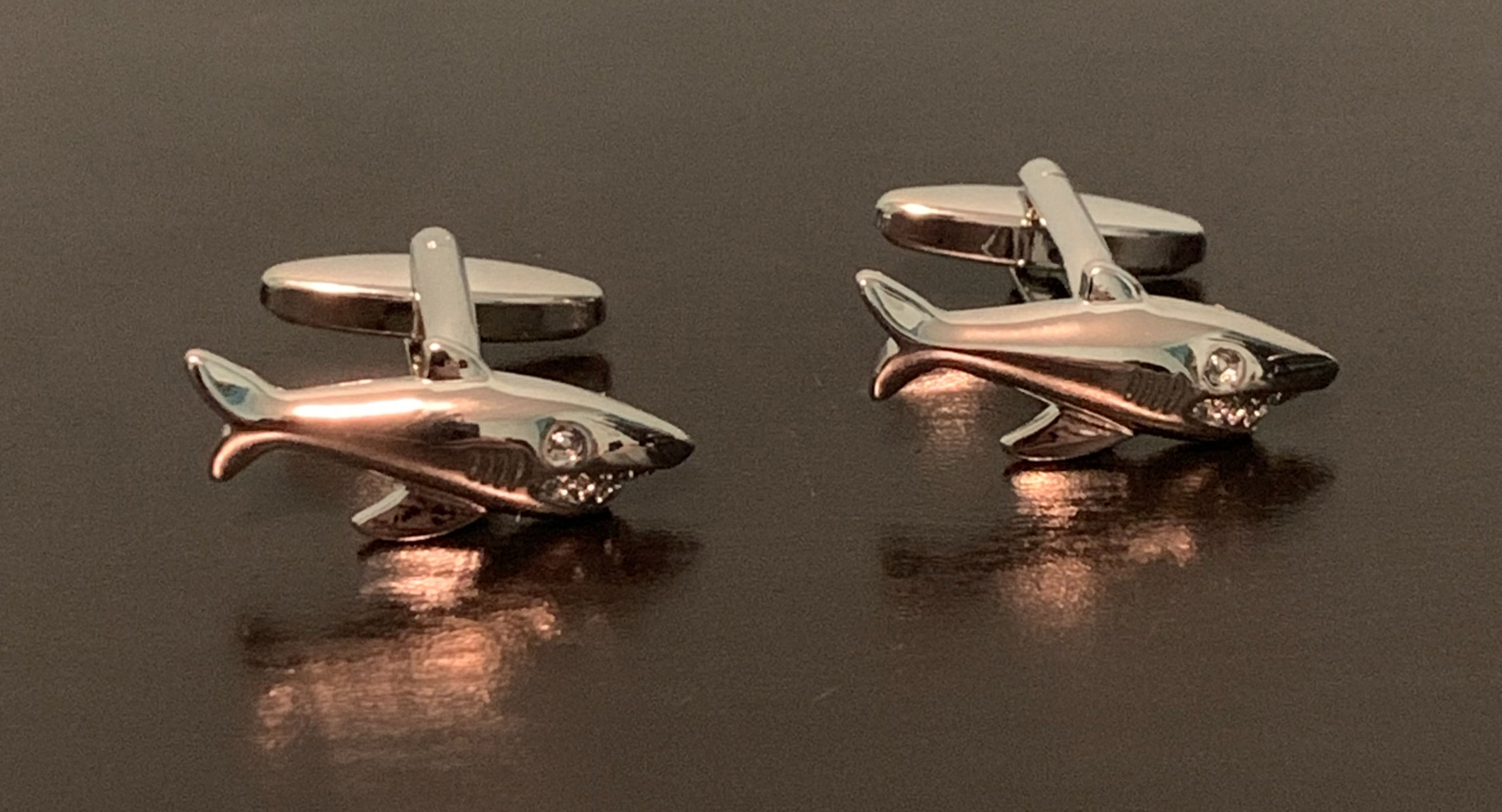 A pair of stylish Shark Tank Cufflinks featuring a unique shark design, perfect for formal occasions.