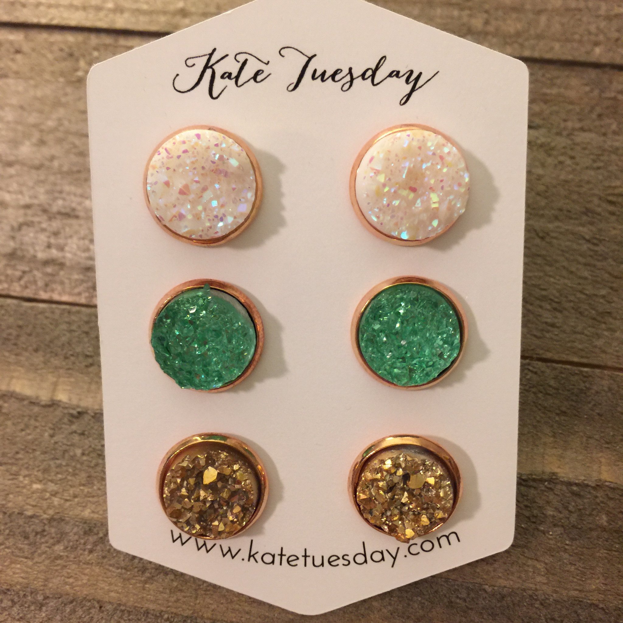 A pair of 12mm druzy earrings in a rose gold setting, showcasing their sparkling texture and elegant design.