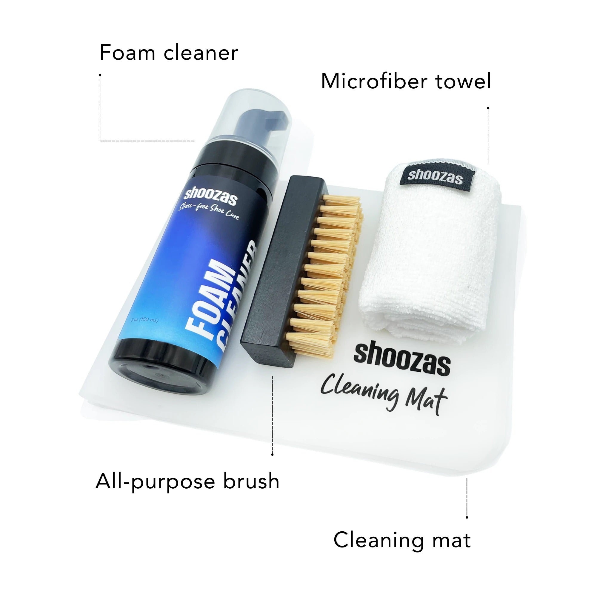 Signature Shoe Cleaning Kit featuring foam cleaner, brush, towel, and storage bag on a cleaning mat.