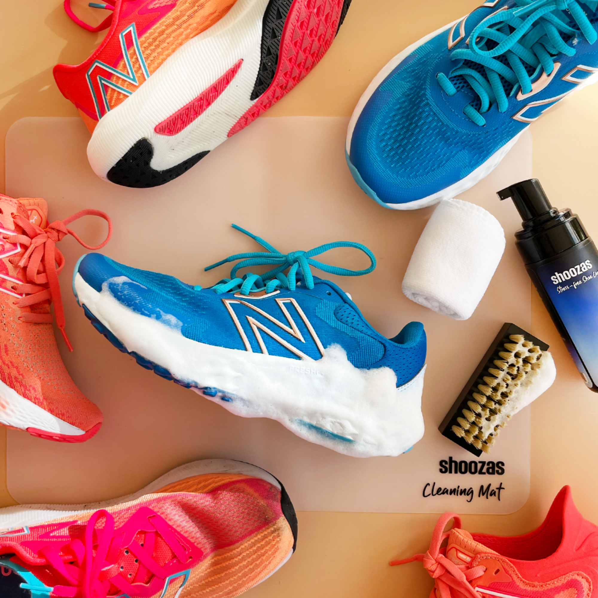 Signature Shoe Cleaning Kit featuring foam cleaner, brush, towel, and storage bag on a cleaning mat.