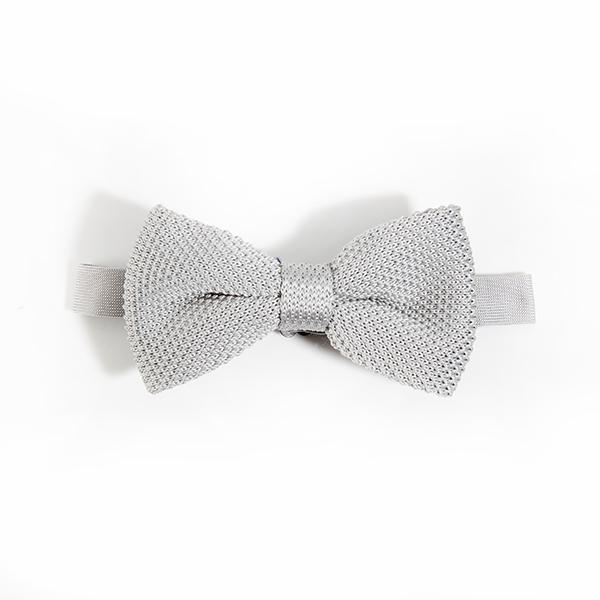 A stylish silver knitted bow tie displayed elegantly, showcasing its unique texture and design.