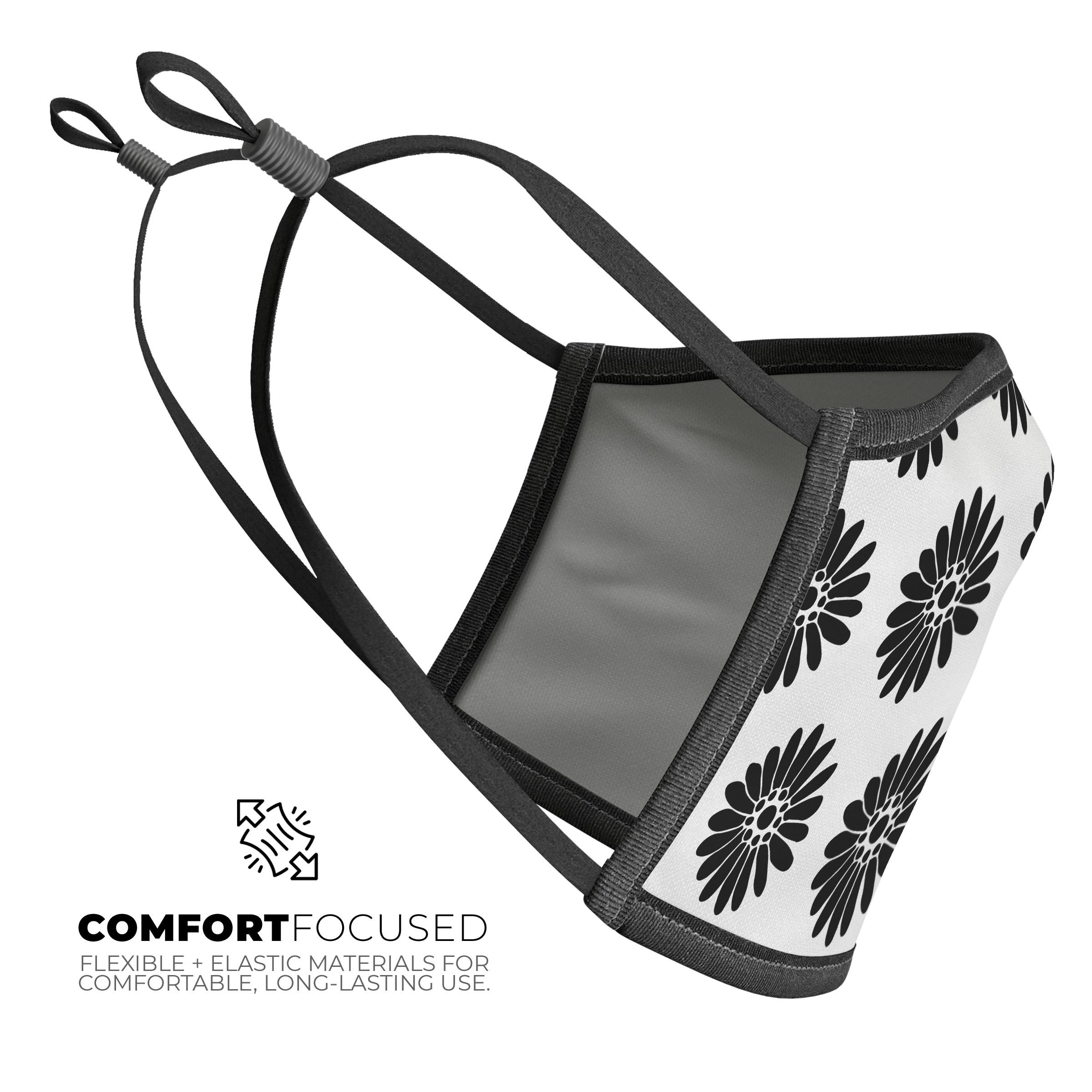 Slate Black Daisy's Mouth Cover with Translucent Backing, showcasing a stylish floral design and adjustable ear-loops.