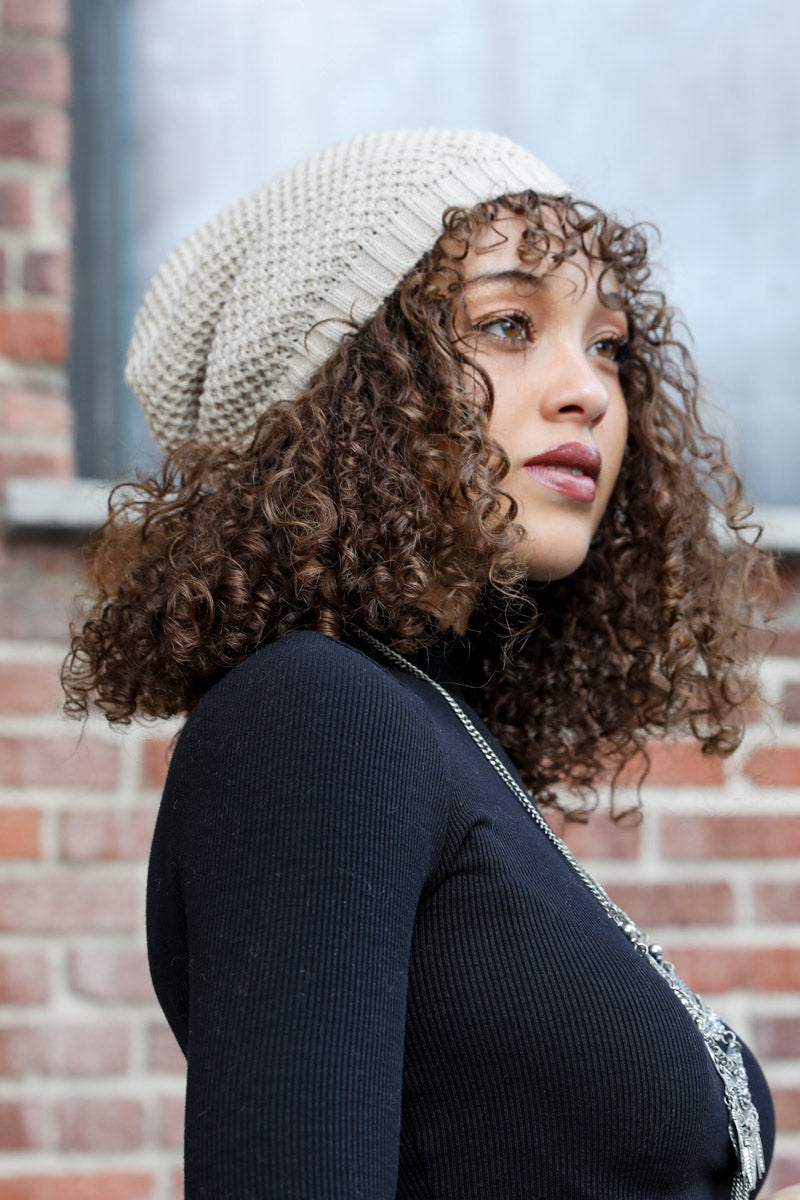 A cozy Slouch Waffle Knit Beanie in various colors, showcasing its soft texture and slouchy fit, perfect for winter wear.