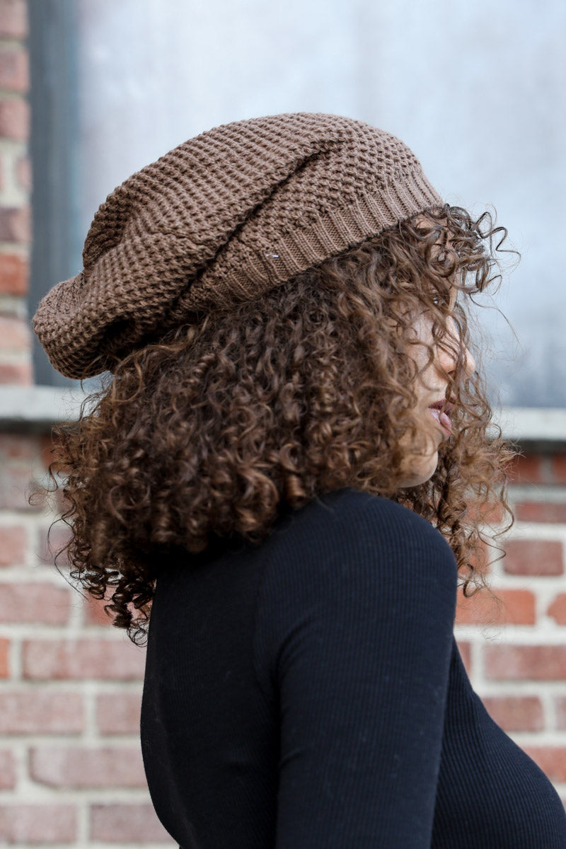 A cozy Slouch Waffle Knit Beanie in various colors, showcasing its soft texture and slouchy fit, perfect for winter wear.