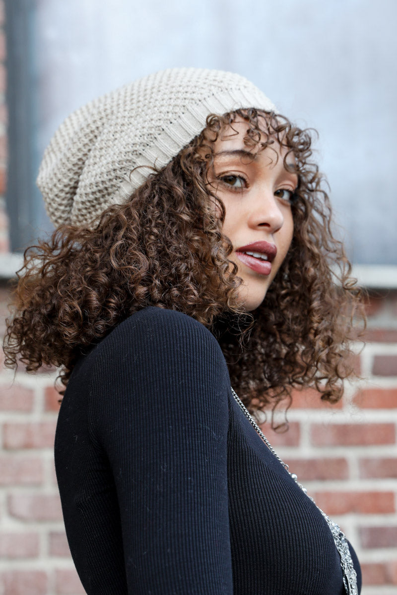 A cozy Slouch Waffle Knit Beanie in various colors, showcasing its soft texture and slouchy fit, perfect for winter wear.