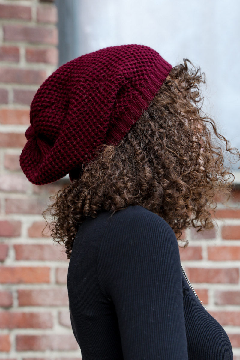 A cozy Slouch Waffle Knit Beanie in various colors, showcasing its soft texture and slouchy fit, perfect for winter wear.