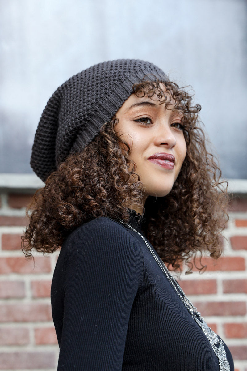 A cozy Slouch Waffle Knit Beanie in various colors, showcasing its soft texture and slouchy fit, perfect for winter wear.