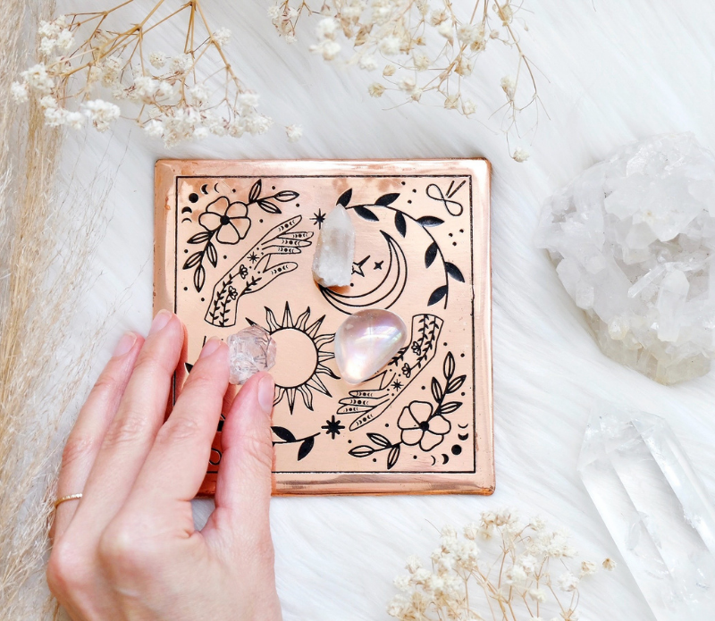 A handmade small copper charging plate with an etched design, measuring 4.5 inches by 4.5 inches, perfect for charging crystals and cleansing energy.