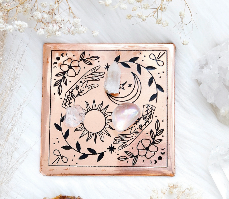 A handmade small copper charging plate with an etched design, measuring 4.5 inches by 4.5 inches, perfect for charging crystals and cleansing energy.