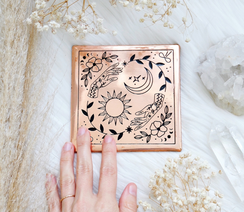 A handmade small copper charging plate with an etched design, measuring 4.5 inches by 4.5 inches, perfect for charging crystals and cleansing energy.