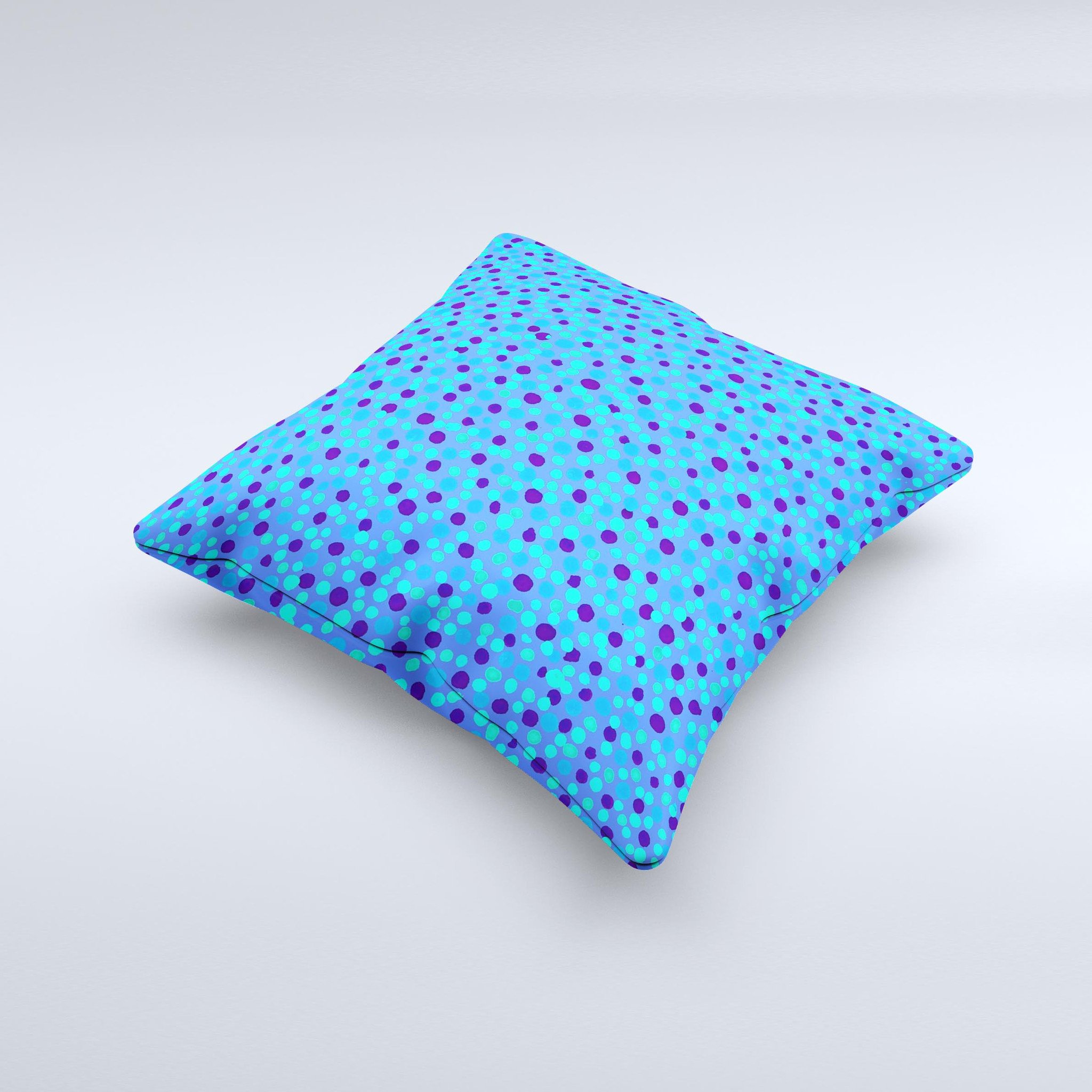 A decorative throw pillow featuring small scattered polka dots in blue ink on a soft fabric, handcrafted in Virginia.