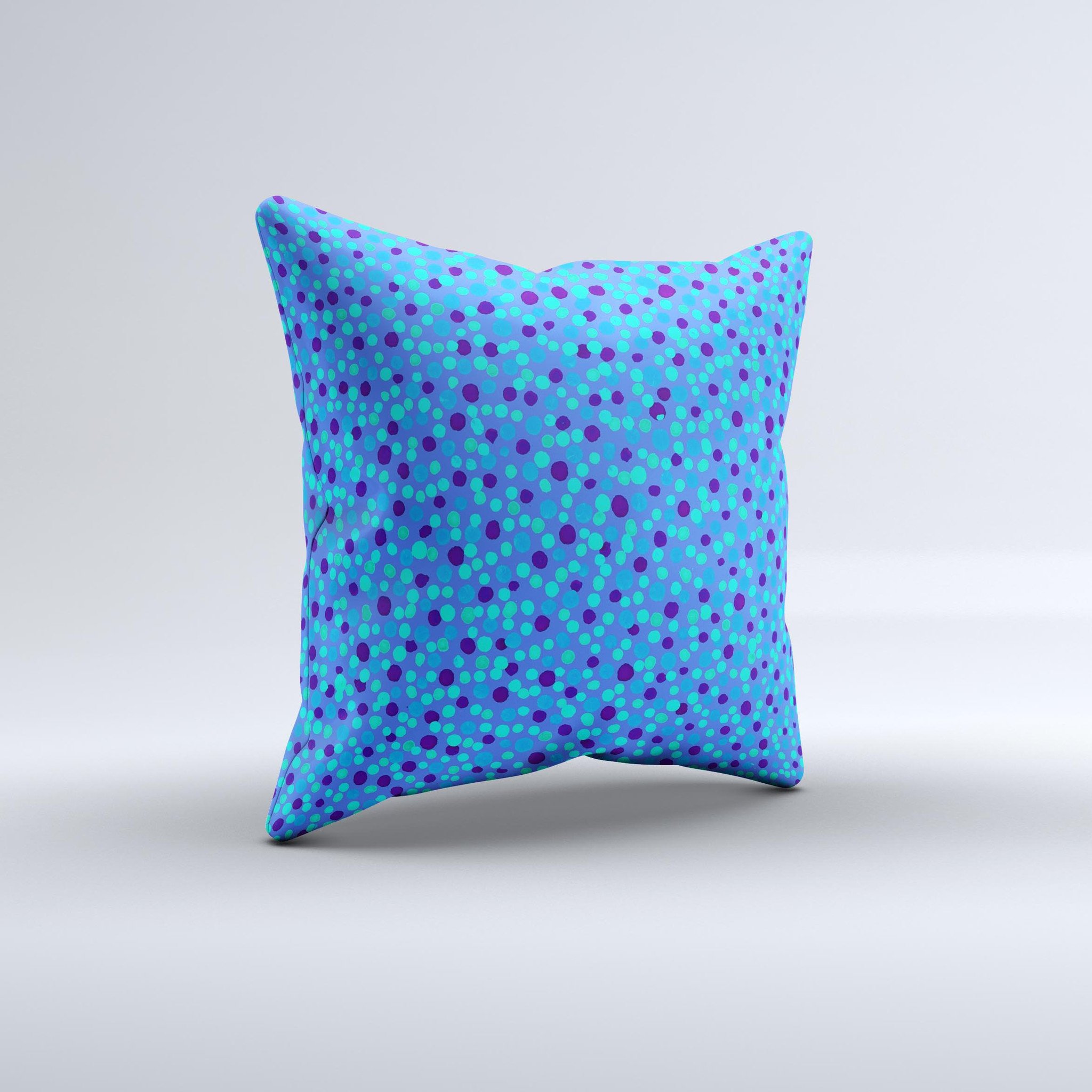 A decorative throw pillow featuring small scattered polka dots in blue ink on a soft fabric, handcrafted in Virginia.