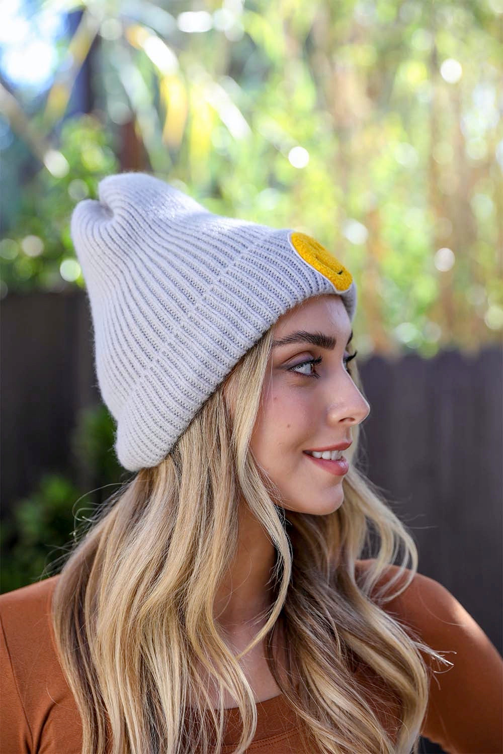 A cozy Smiley Face Ribbed Beanie in soft fabric featuring a cheerful smiley face design, perfect for winter wear.