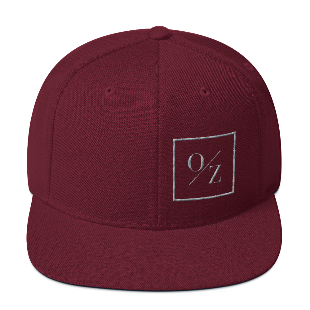 A stylish Snapback Hat with a flat brim, structured design, and puff embroidered O/Z logo on the front.