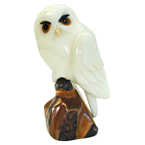 Hand-carved Snowy Owl figurine made from tagua nut, showcasing intricate details and natural colors, symbolizing eco-friendly craftsmanship.