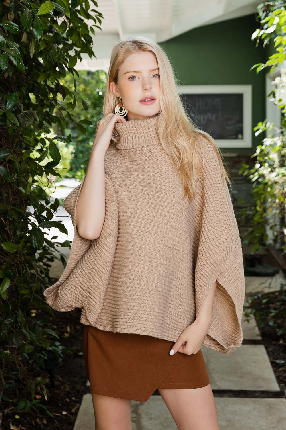 SnugStyle Turtleneck Ribbed Knit Poncho with Armholes in a cozy setting, showcasing its stylish ribbed texture and turtleneck design.