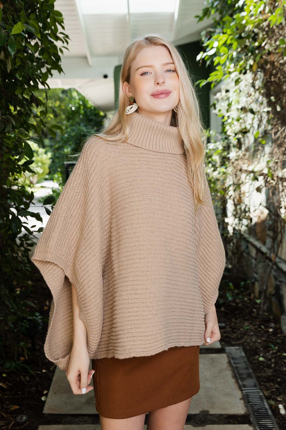 SnugStyle Turtleneck Ribbed Knit Poncho with Armholes in a cozy setting, showcasing its stylish ribbed texture and turtleneck design.