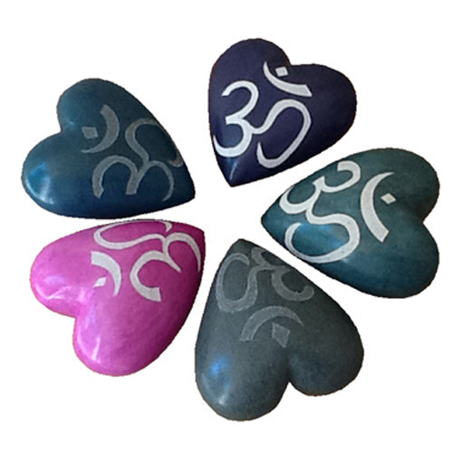 Handcrafted soapstone heart featuring an etched Om symbol, showcasing vibrant colors and smooth finish, symbolizing spirituality and artisan craftsmanship.