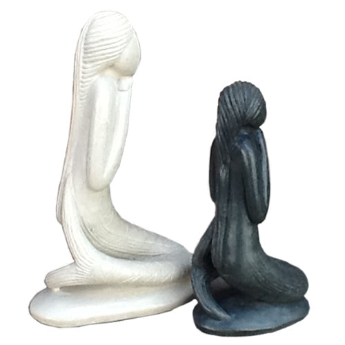 Hand-carved soapstone mermaid sculptures in white and gray, showcasing intricate details and craftsmanship.