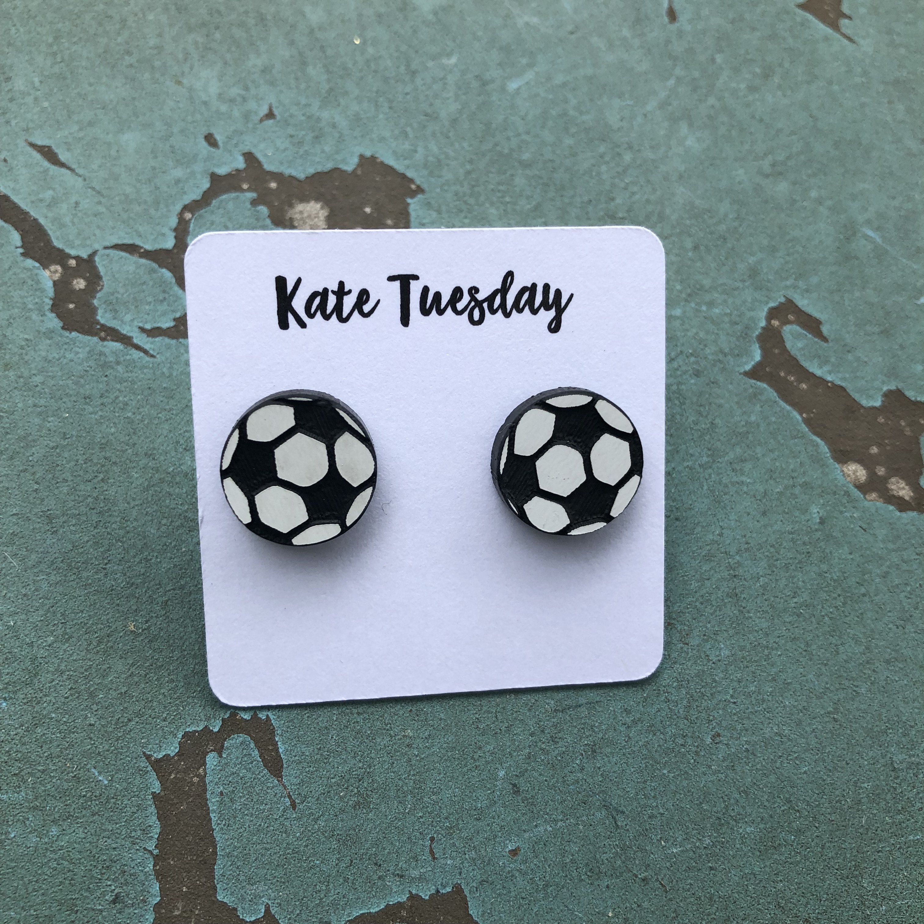 A pair of 12mm soccer stud earrings featuring a classic black and white soccer ball design with black back sides.