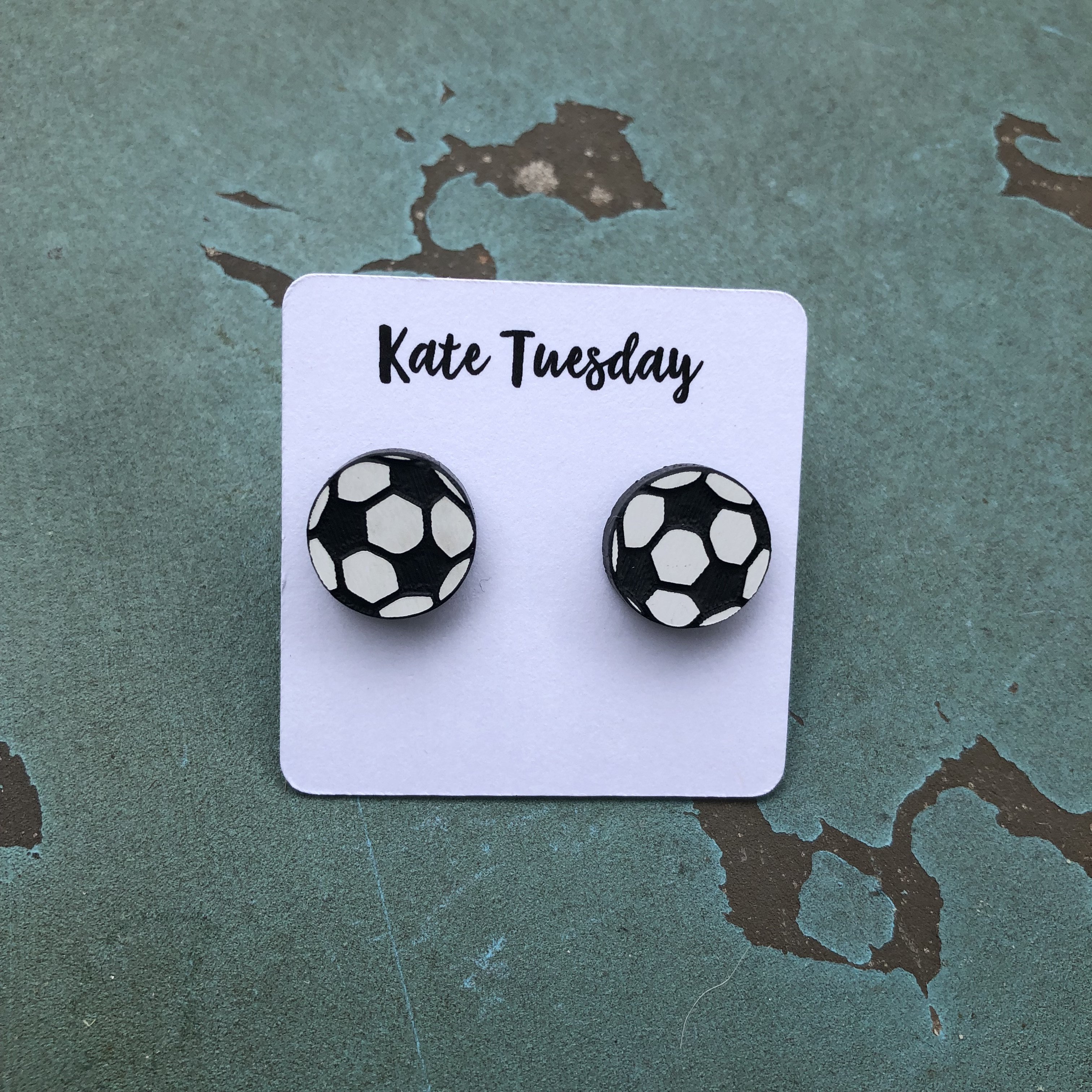 A pair of 12mm soccer stud earrings featuring a classic black and white soccer ball design with black back sides.