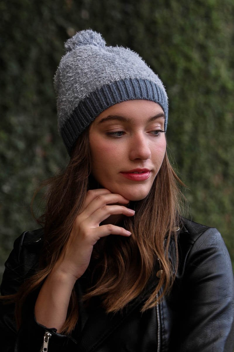 A stylish soft furry pom knit beanie in a cozy blend of nylon and acrylic, featuring a playful pom on top, perfect for winter wear.