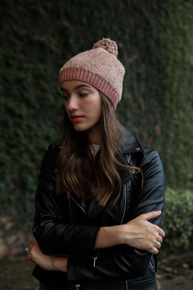 A stylish soft furry pom knit beanie in a cozy blend of nylon and acrylic, featuring a playful pom on top, perfect for winter wear.