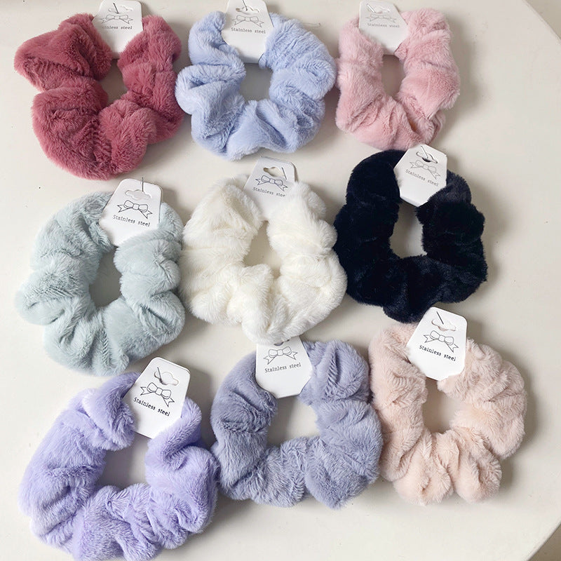 A set of 9 solid color plush hair ties in vibrant hues, showcasing their soft and fluffy texture, perfect for stylish hairstyles.