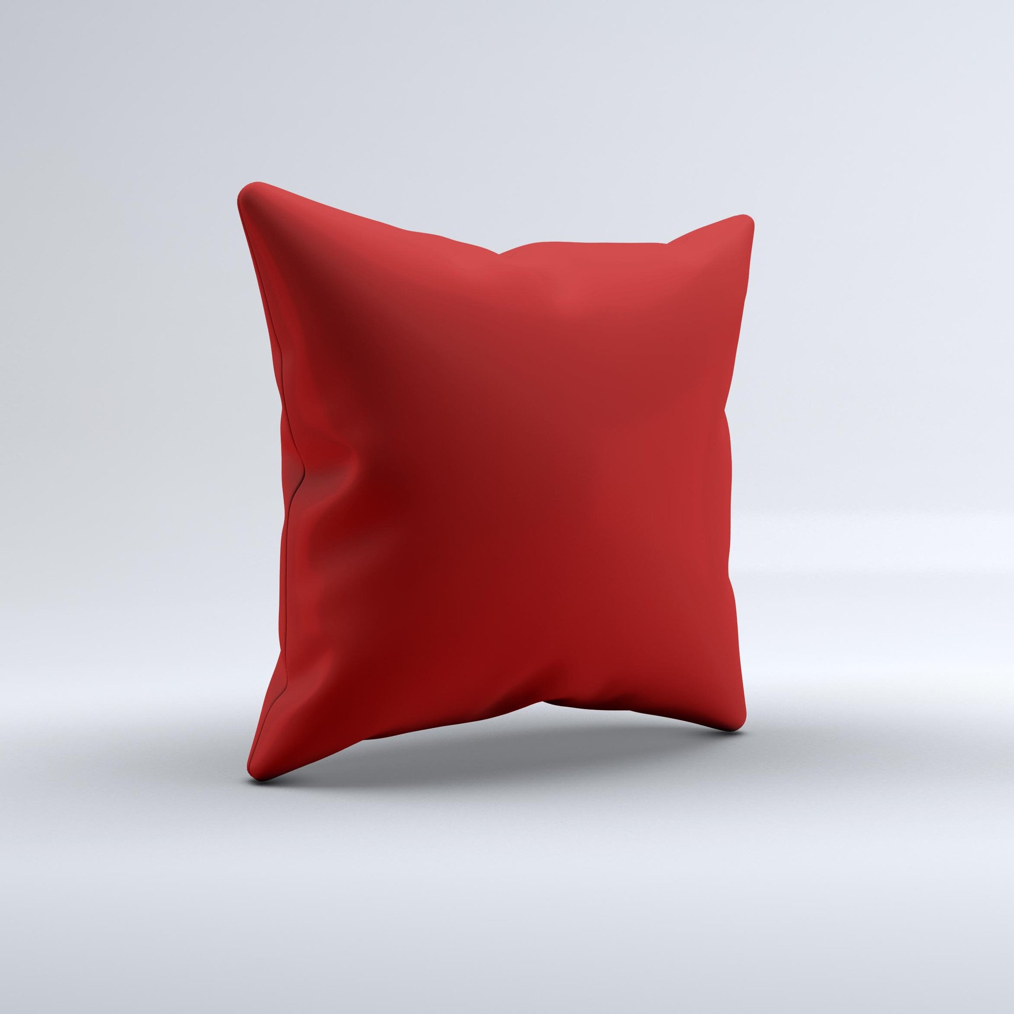 Solid dark red decorative throw pillow with ink-fuzed design, handcrafted in Virginia, showcasing unique imperfections.