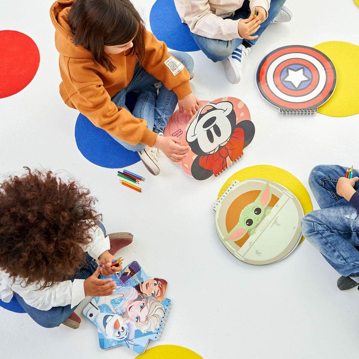 Children sitting with themed notebooks