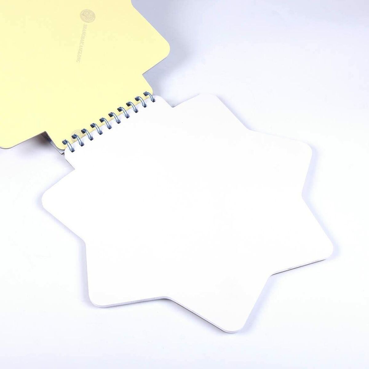 Star-shaped spiral-bound notebook page