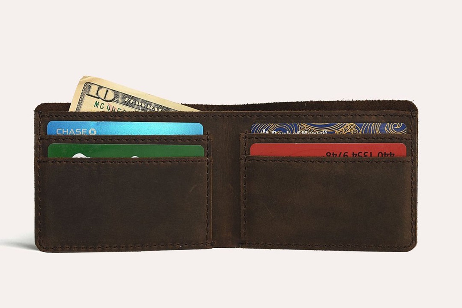 Step Up Wallet showcasing four card slots and a bill compartment in rich leather with dark stitching.