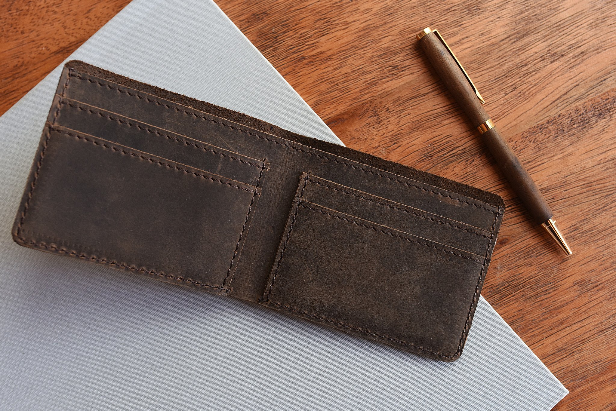 Step Up Wallet showcasing four card slots and a bill compartment in rich leather with dark stitching.