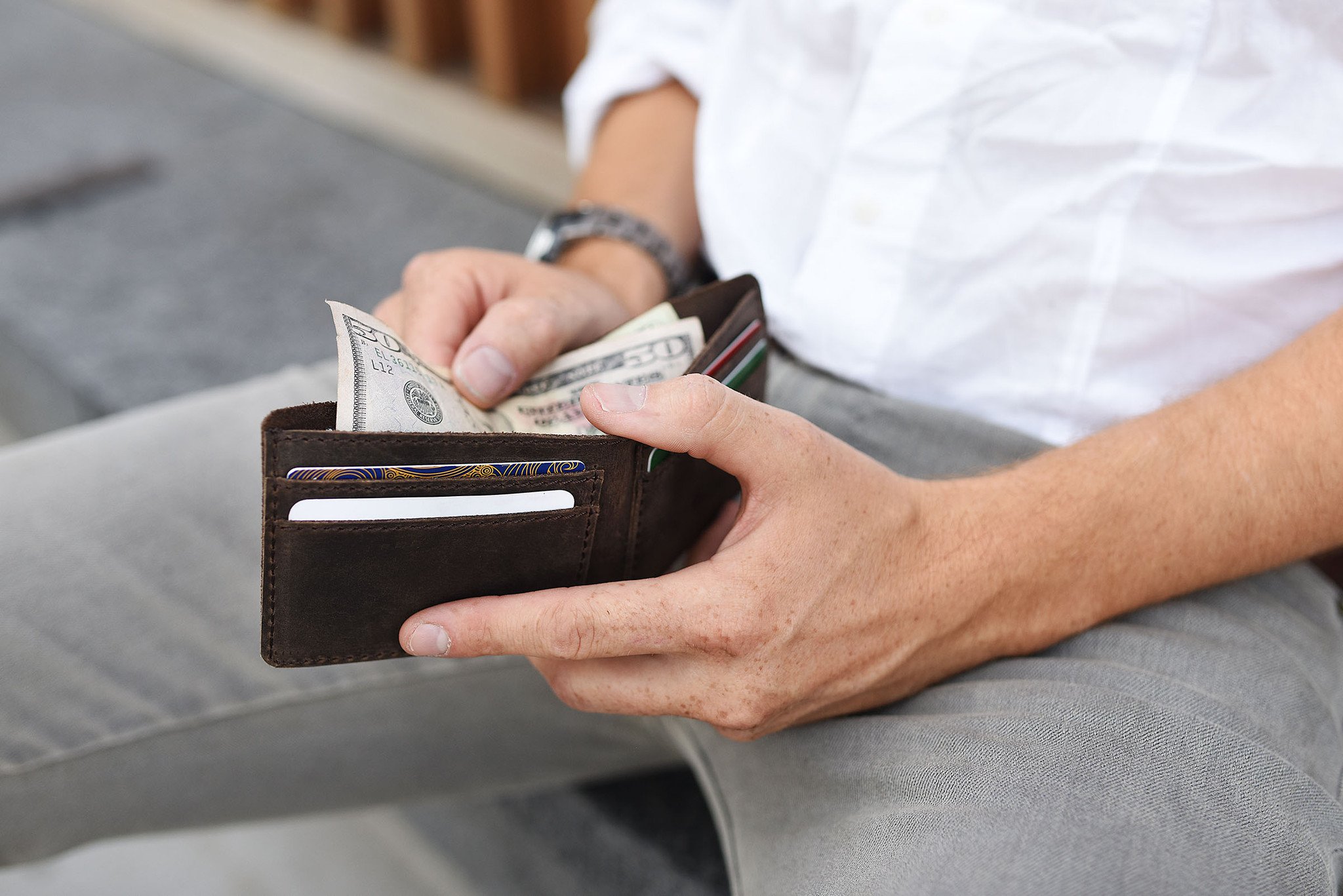 Step Up Wallet showcasing four card slots and a bill compartment in rich leather with dark stitching.