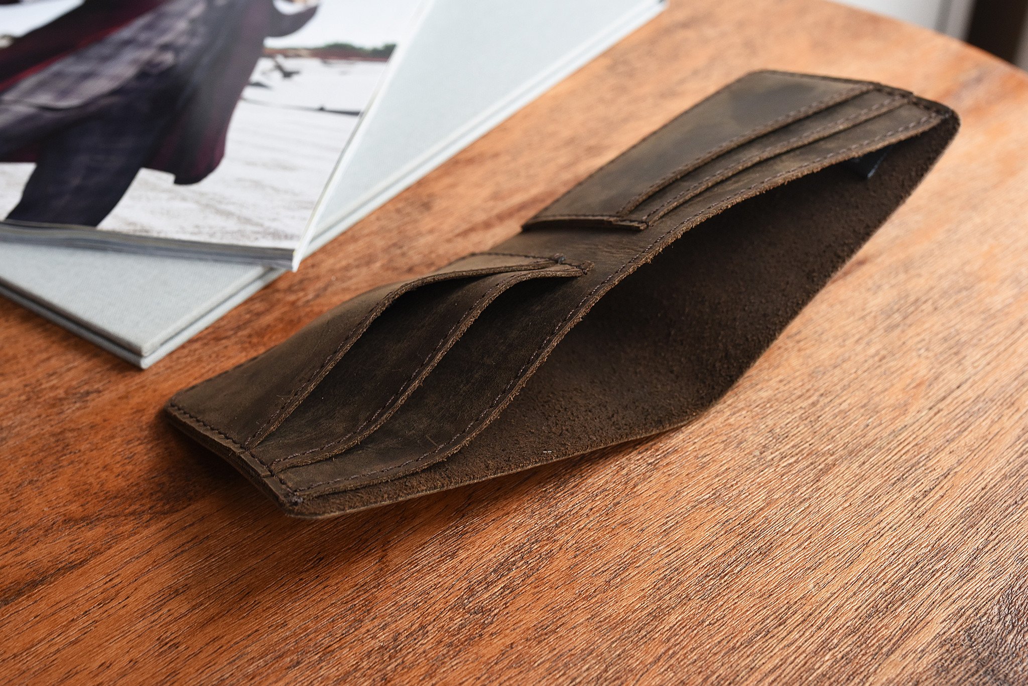 Step Up Wallet showcasing four card slots and a bill compartment in rich leather with dark stitching.