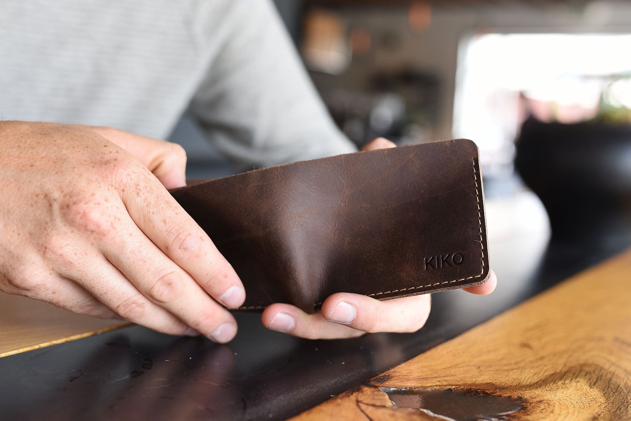 Straight Cut Bifold wallet made of high-quality leather with rustic dark brown color and antique-style wear spots.