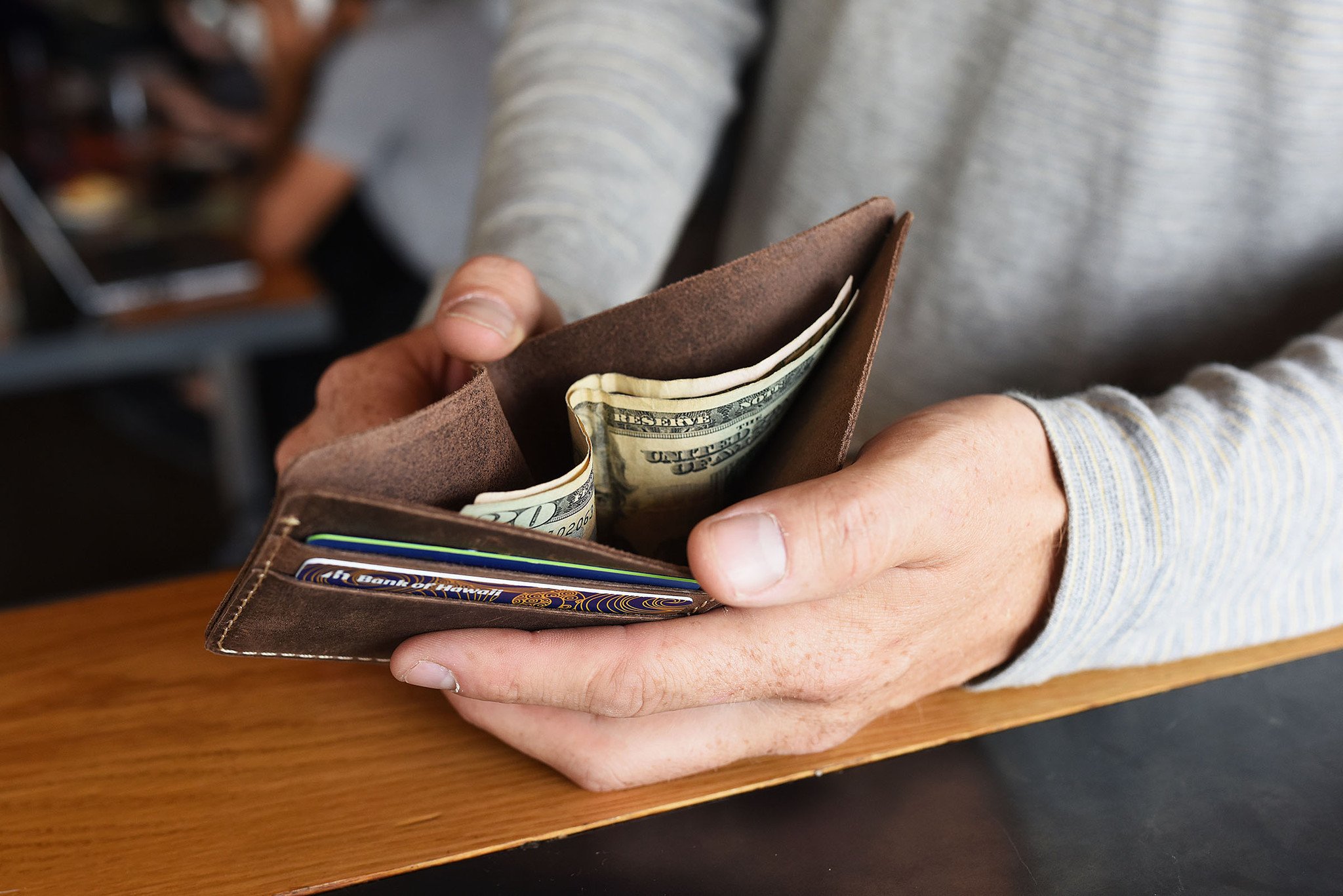 Straight Cut Bifold wallet made of high-quality leather with rustic dark brown color and antique-style wear spots.