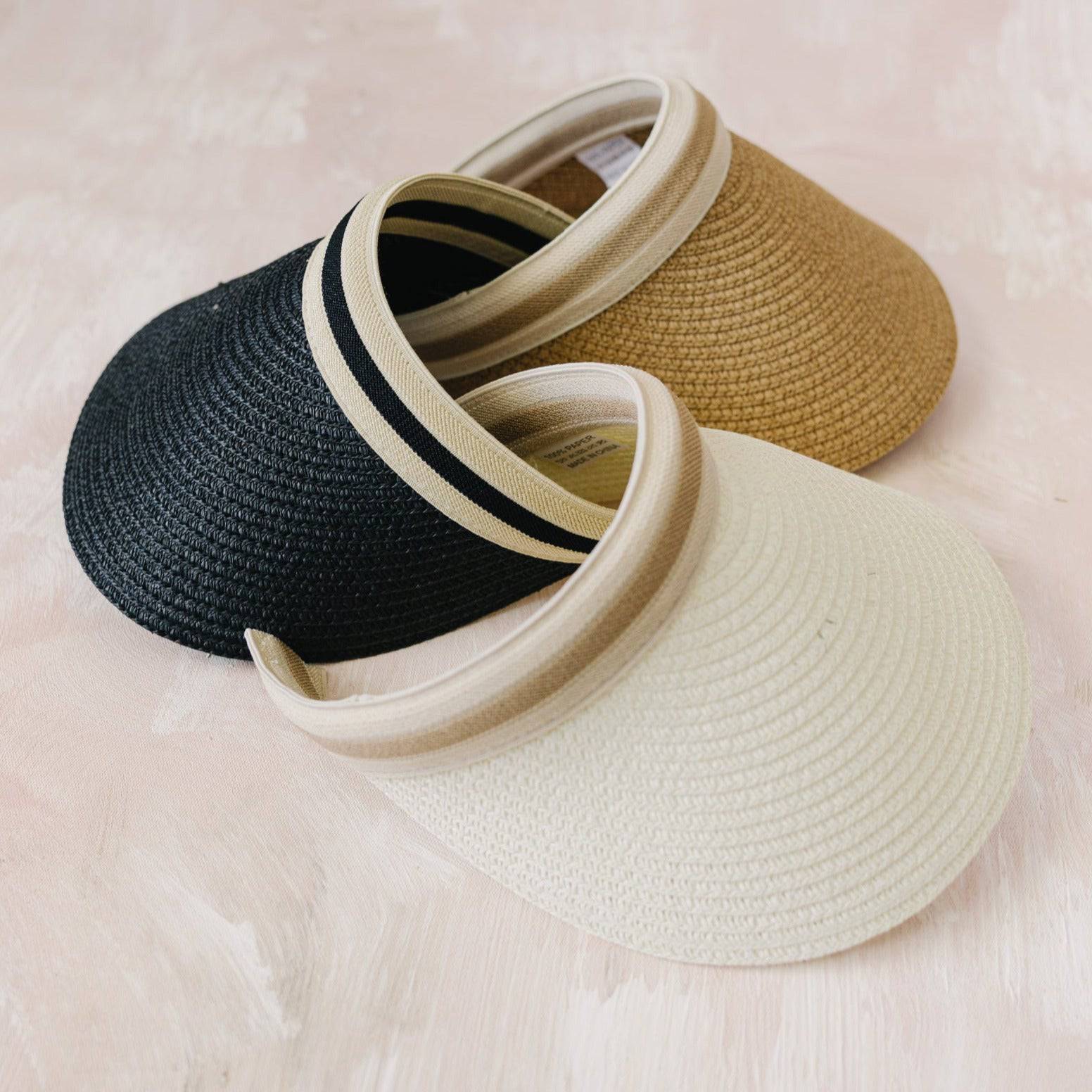 Stylish straw visor with adjustable band, perfect for summer sun protection.