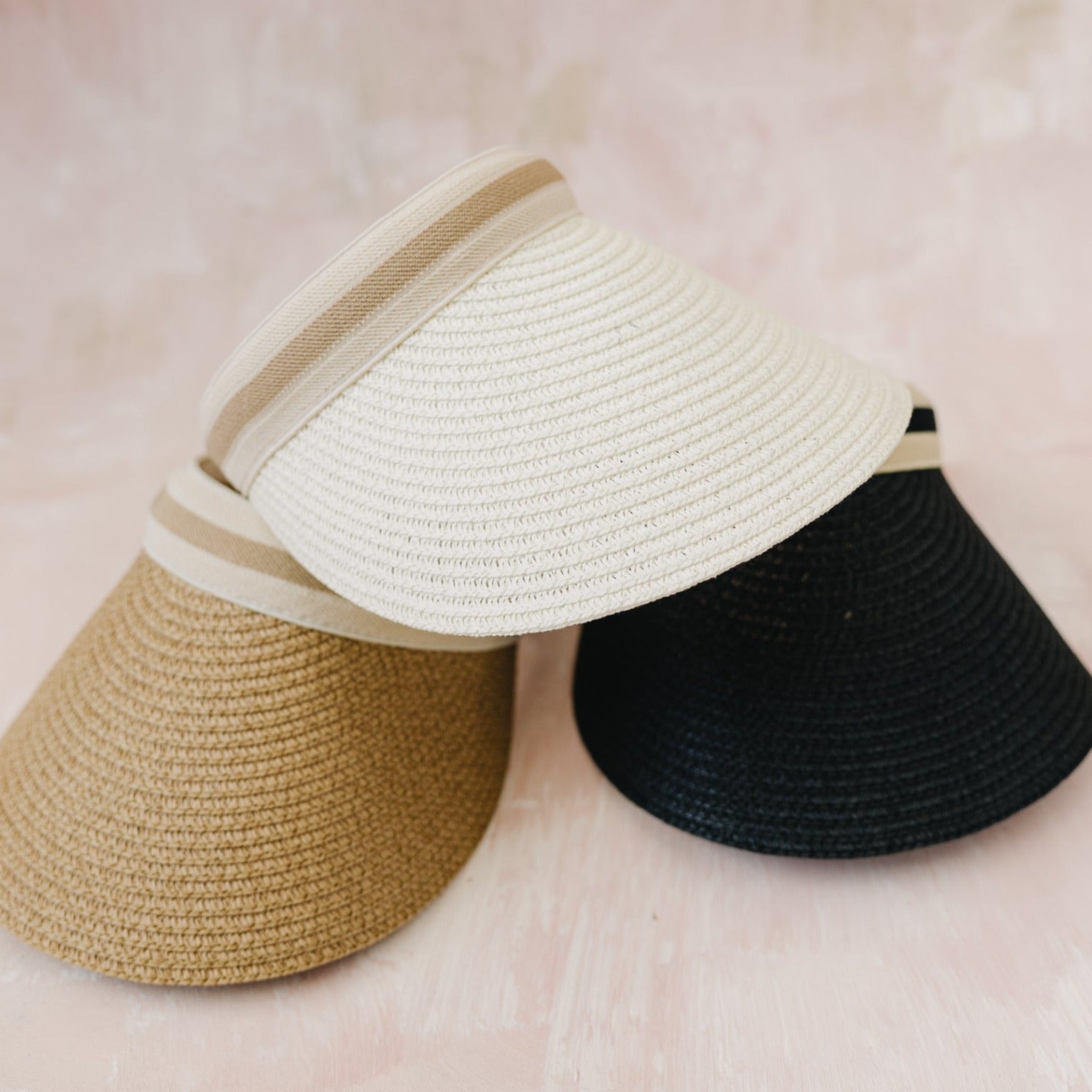 Stylish straw visor with adjustable band, perfect for summer sun protection.