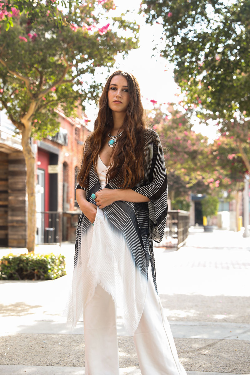 A stylish Stripe Woven Dip Dyed Kimono featuring a feathery texture and vibrant dip-dye pattern, perfect for layering.