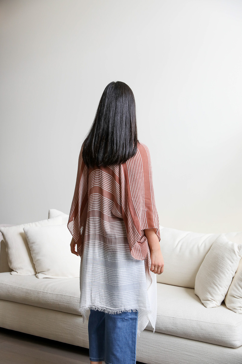 A stylish Stripe Woven Dip Dyed Kimono featuring a feathery texture and vibrant dip-dye pattern, perfect for layering.