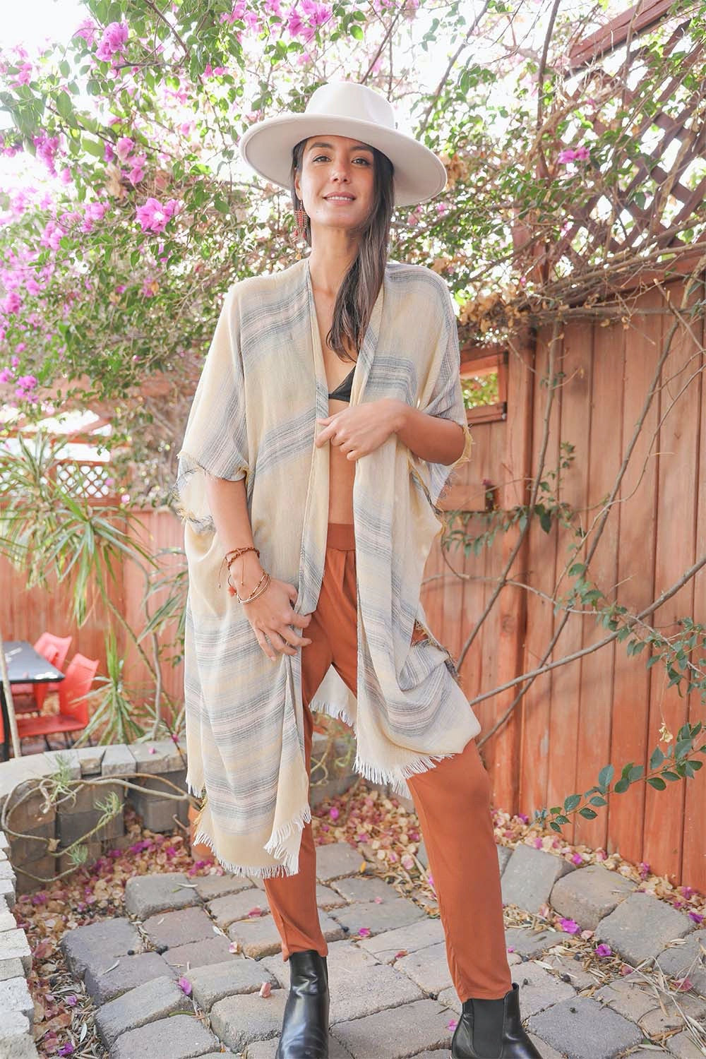 A vibrant striped frayed kimono featuring colorful patterns, perfect for layering and keeping warm on cool nights.