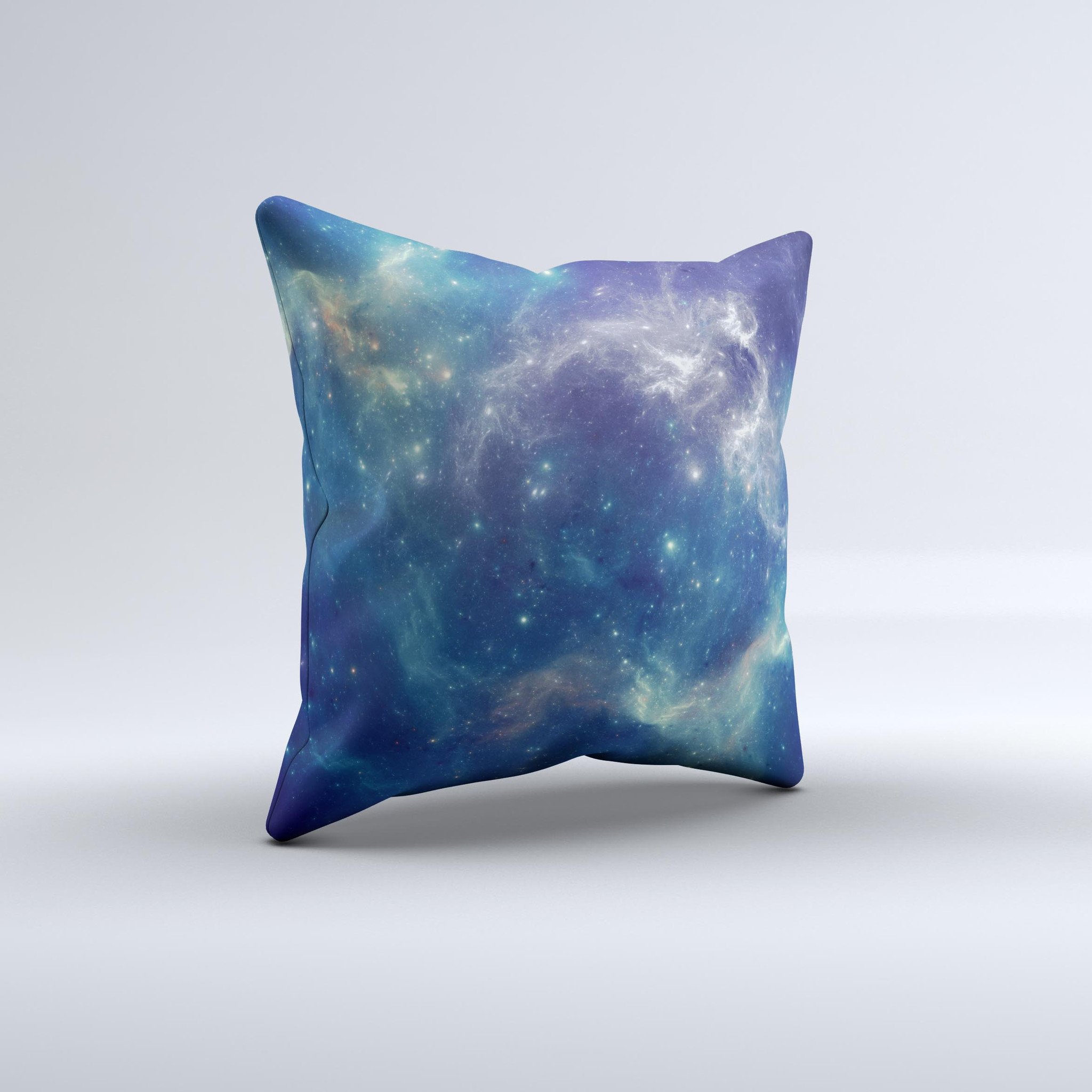 A decorative throw pillow featuring a subtle blue and green nebula design, handcrafted in Virginia with high thread count fabric and polyester filling.