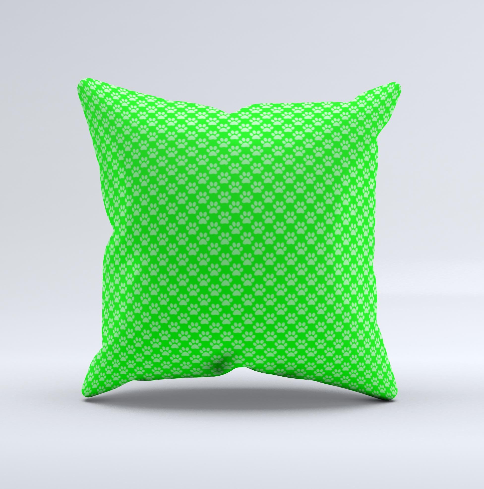 A decorative throw pillow featuring subtle green paw prints on a soft fabric, handcrafted in Virginia, showcasing unique design and quality.